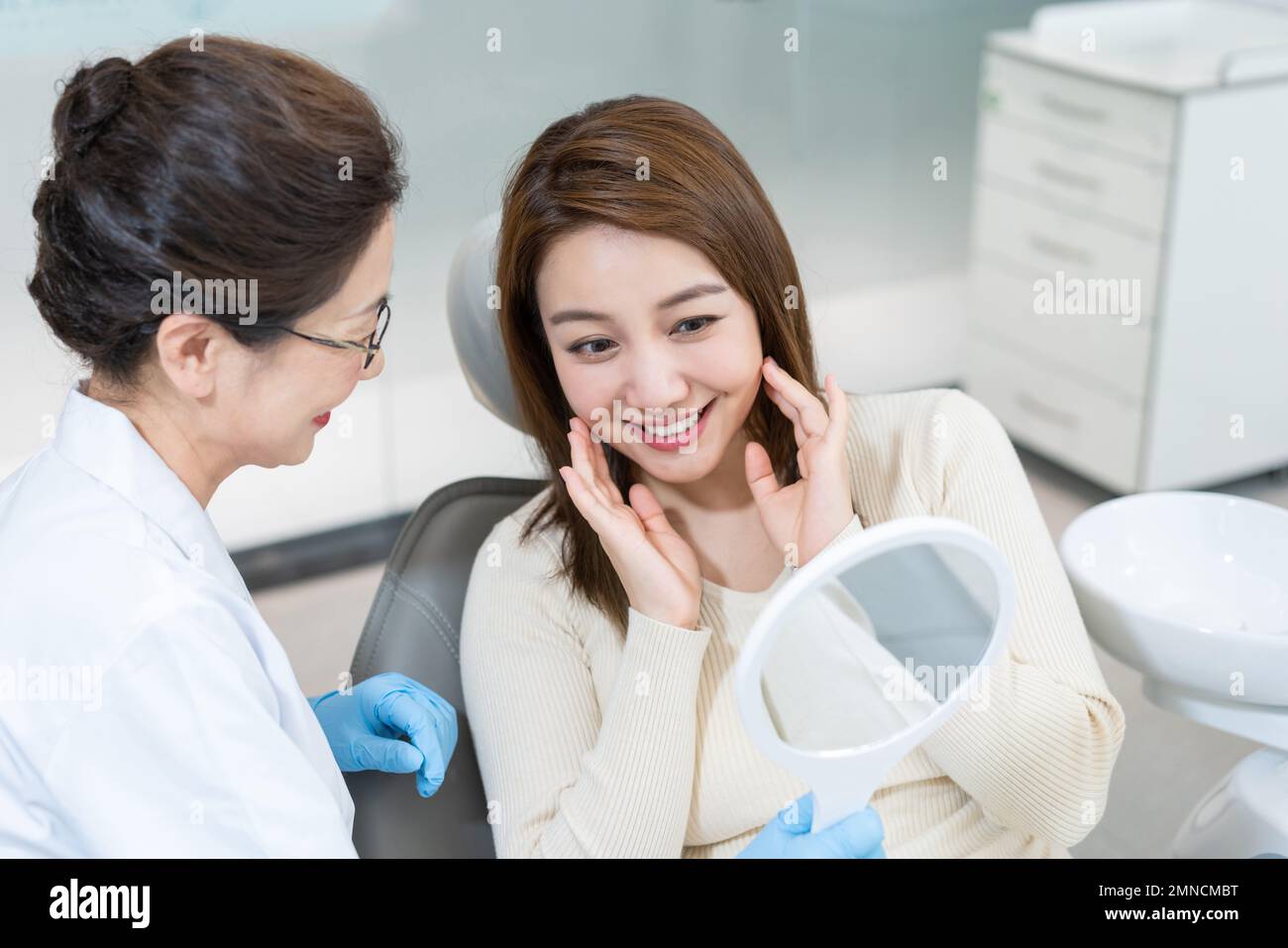 Doctors give patients in the dental clinic matching teeth Stock Photo