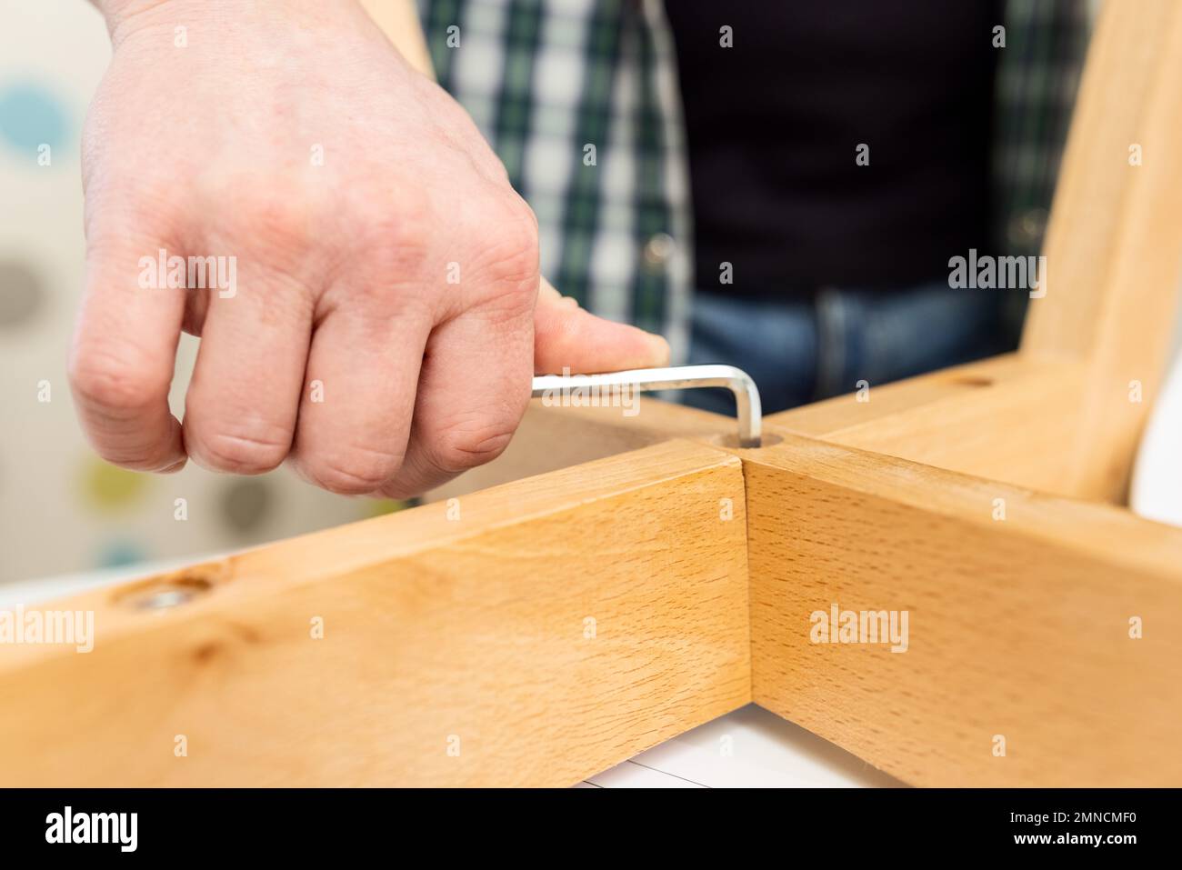 Selfassembly furniture concept. The young man himself assembling
