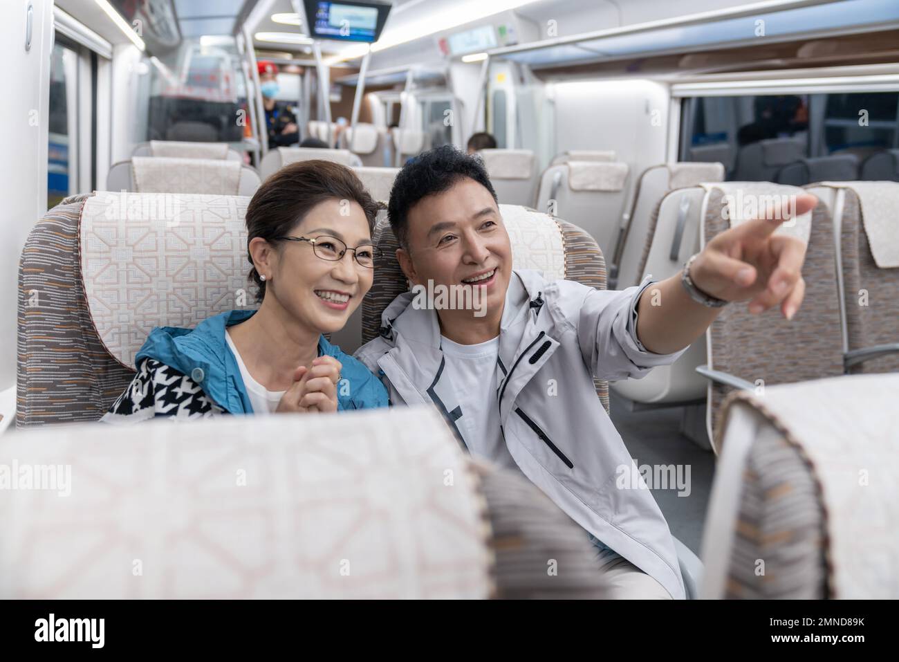 Happy elderly couple take the subway Stock Photo