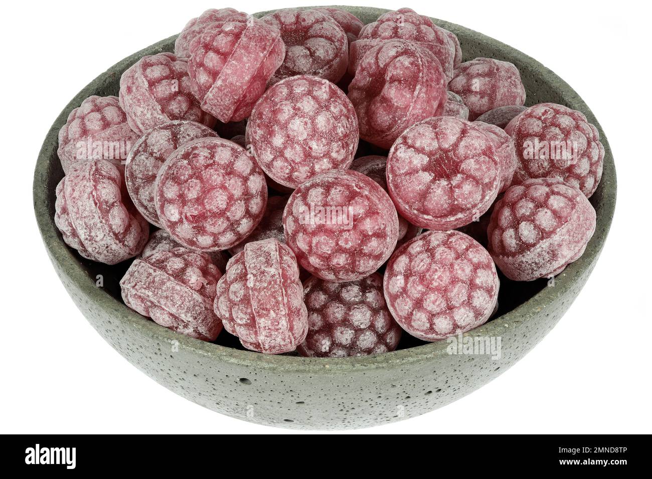 raspberry candies in a concrete bowl isolated on white background Stock Photo
