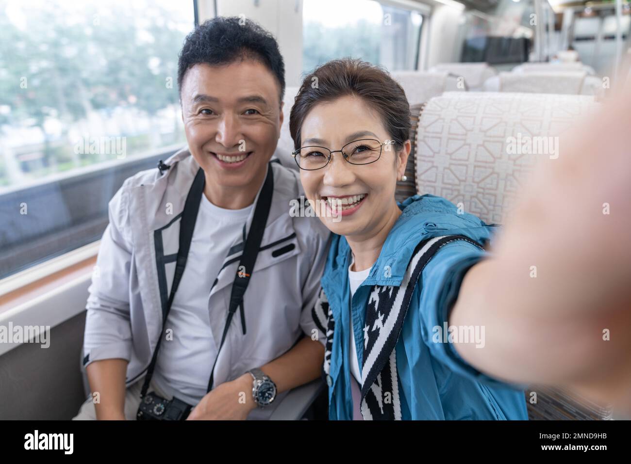 Happy elderly couple take the subway Stock Photo