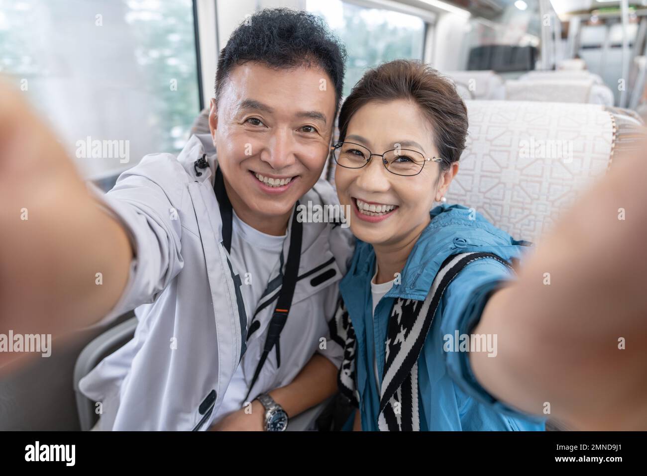 Happy elderly couple take the subway Stock Photo