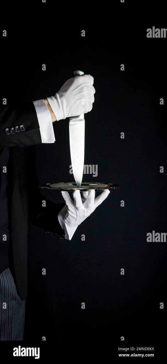 Isolated Close Up of Sharp Knife being Served on Silver Tray. Concept of Butler Did It Classic Murder Mystery Stock Photo