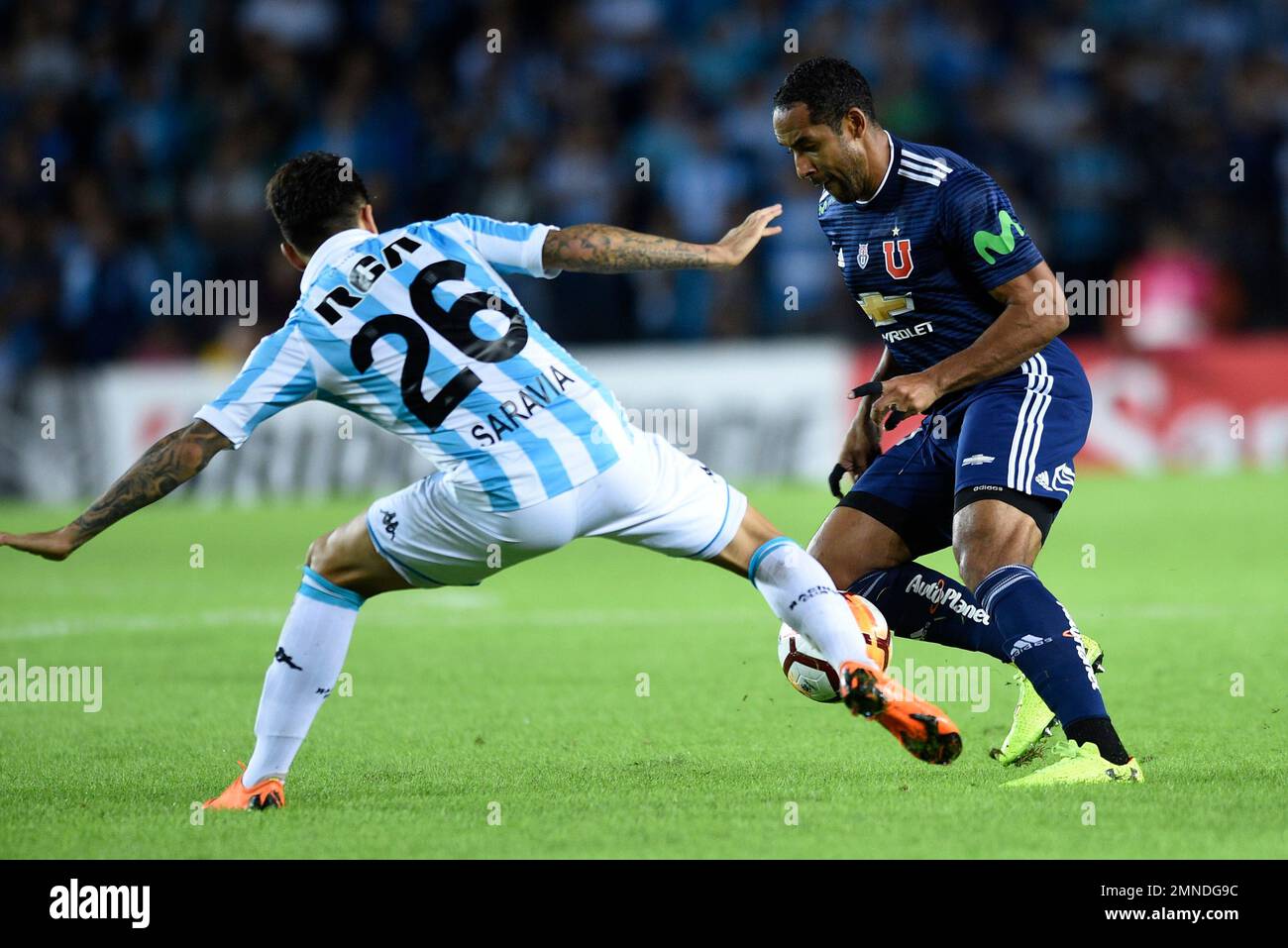 Jean Beausejour of Chile's Universidad de Chile, right, fights for the ball with Renzo Saravia