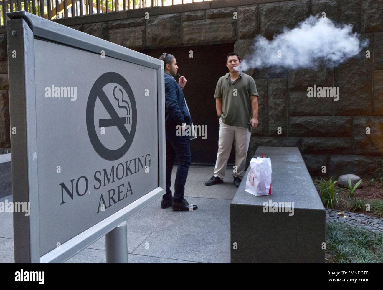 Office workers take a vaping break in downtown Los Angeles on Thursday, May  3, 2018. Federal health officials on Tuesday announced a nationwide  crackdown on underage use of a popular e-cigarette brand