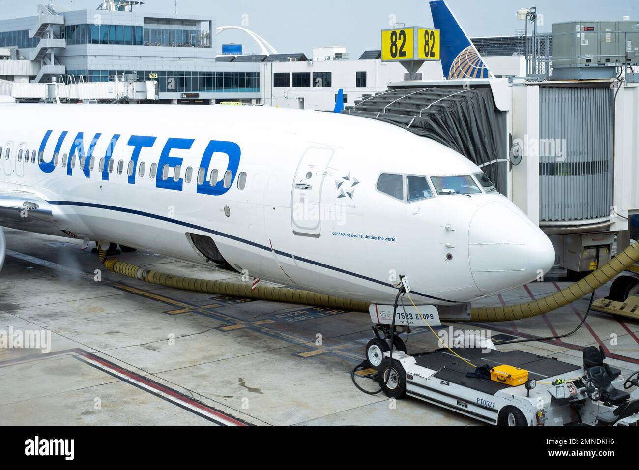 A United Airlines plane gets serviced at an airport in the United States. Stock Photo