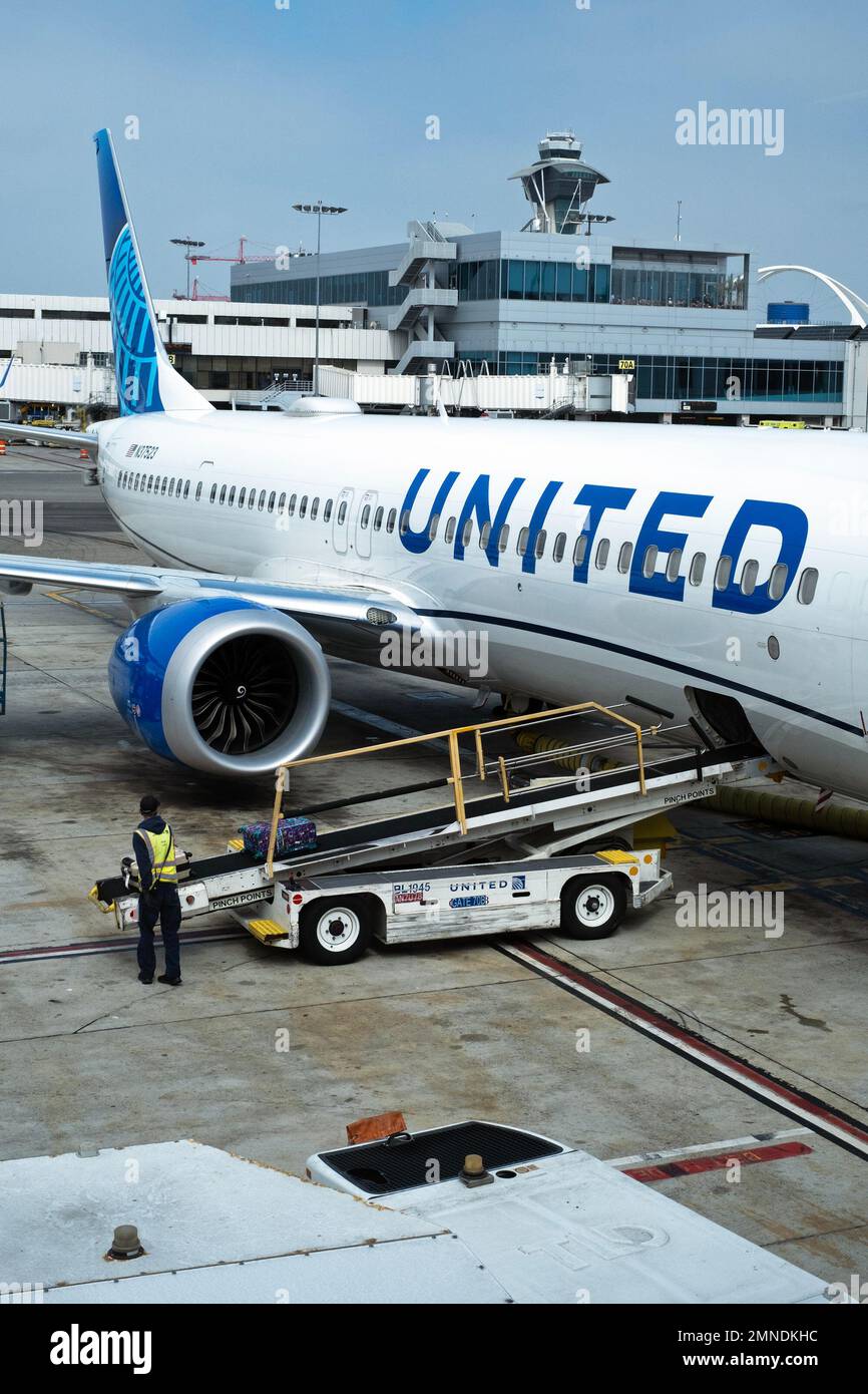 A United Airlines plane gets serviced at an airport in the United States. Stock Photo