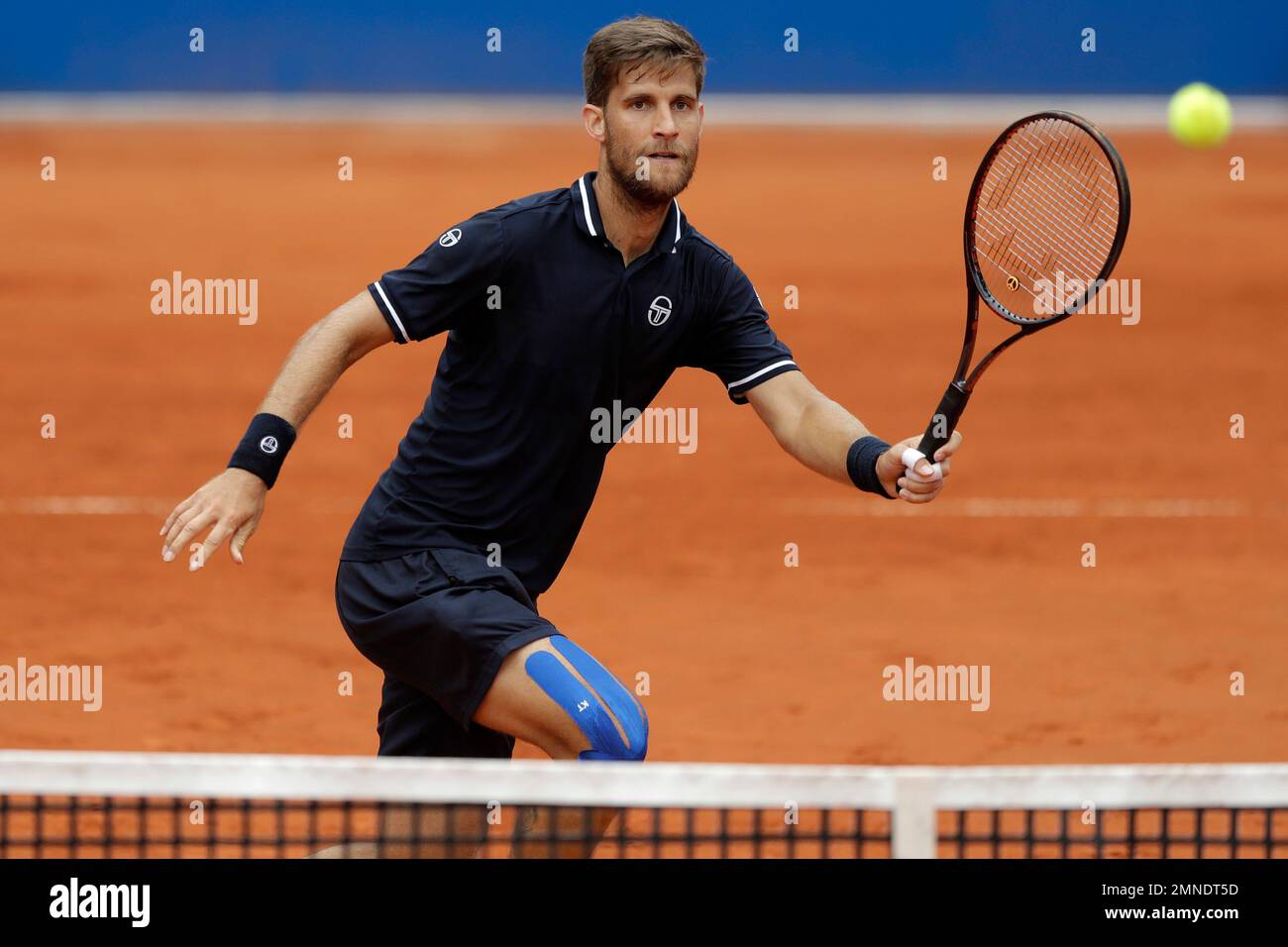 Martin Klizan of Slovakia returns the ball to Mirza Basic of Bosnia and  Herzegovina during the men's second round match at the ATP tennis  tournament in Munich, Germany, Wednesday, May 2, 2018. (