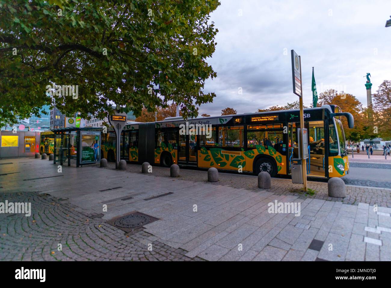 Bus stop Schlossplatz with eco-friendly city bus, city centre, Stuttgart, Baden-Württemberg, Southern Germany, Europe Stock Photo