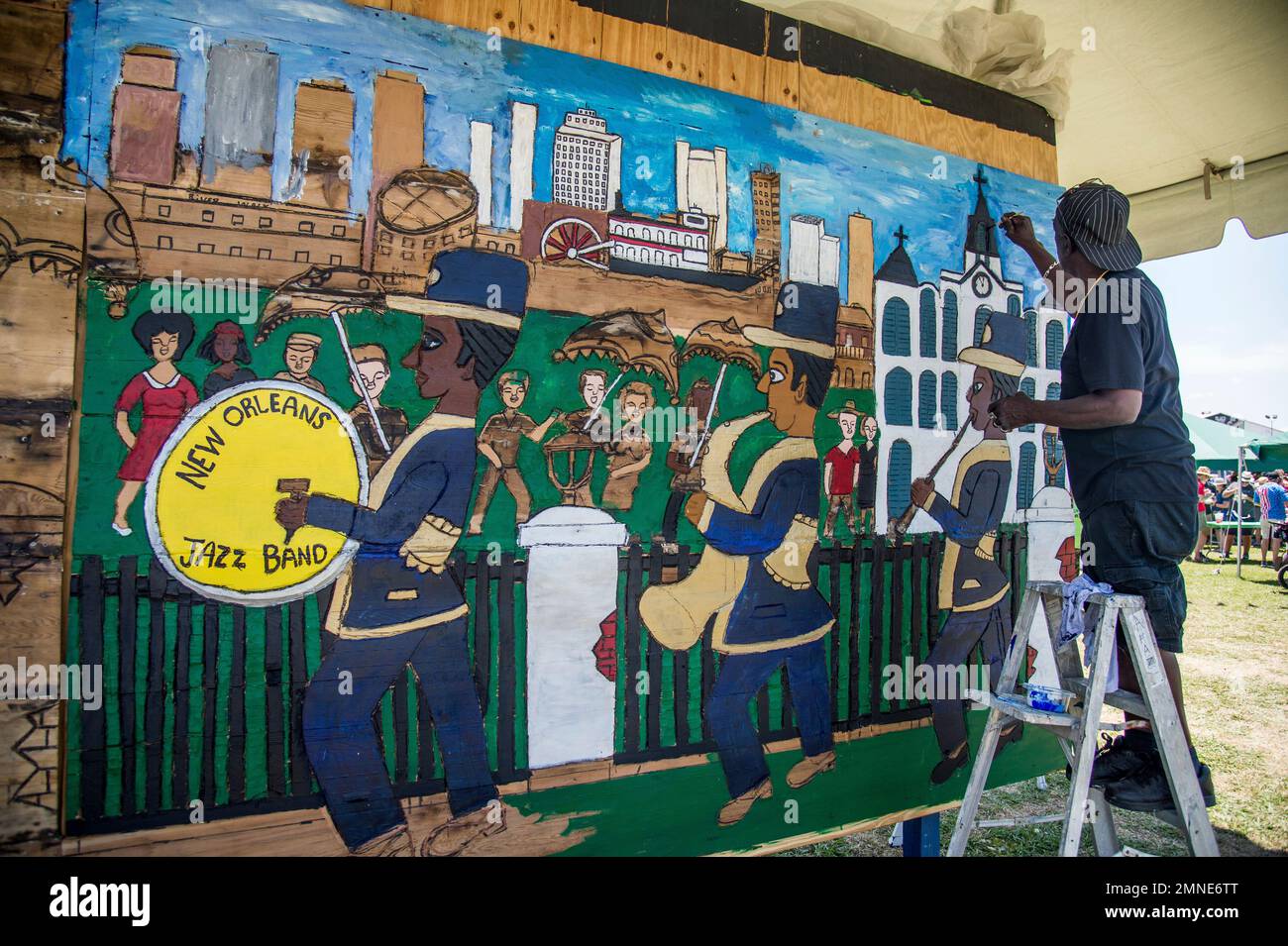 Artist Charles Gillman Sr. paints a mural at the New Orleans Jazz and