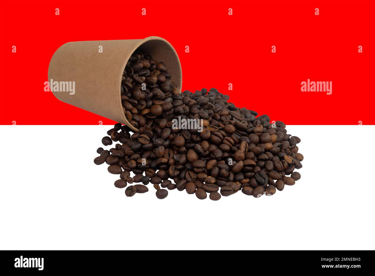 An overturned disposable paper cup filled with roasted coffee beans ...