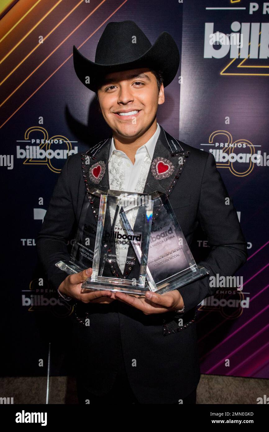 Christian Nodal poses with the awards for new artist of the year, solo
