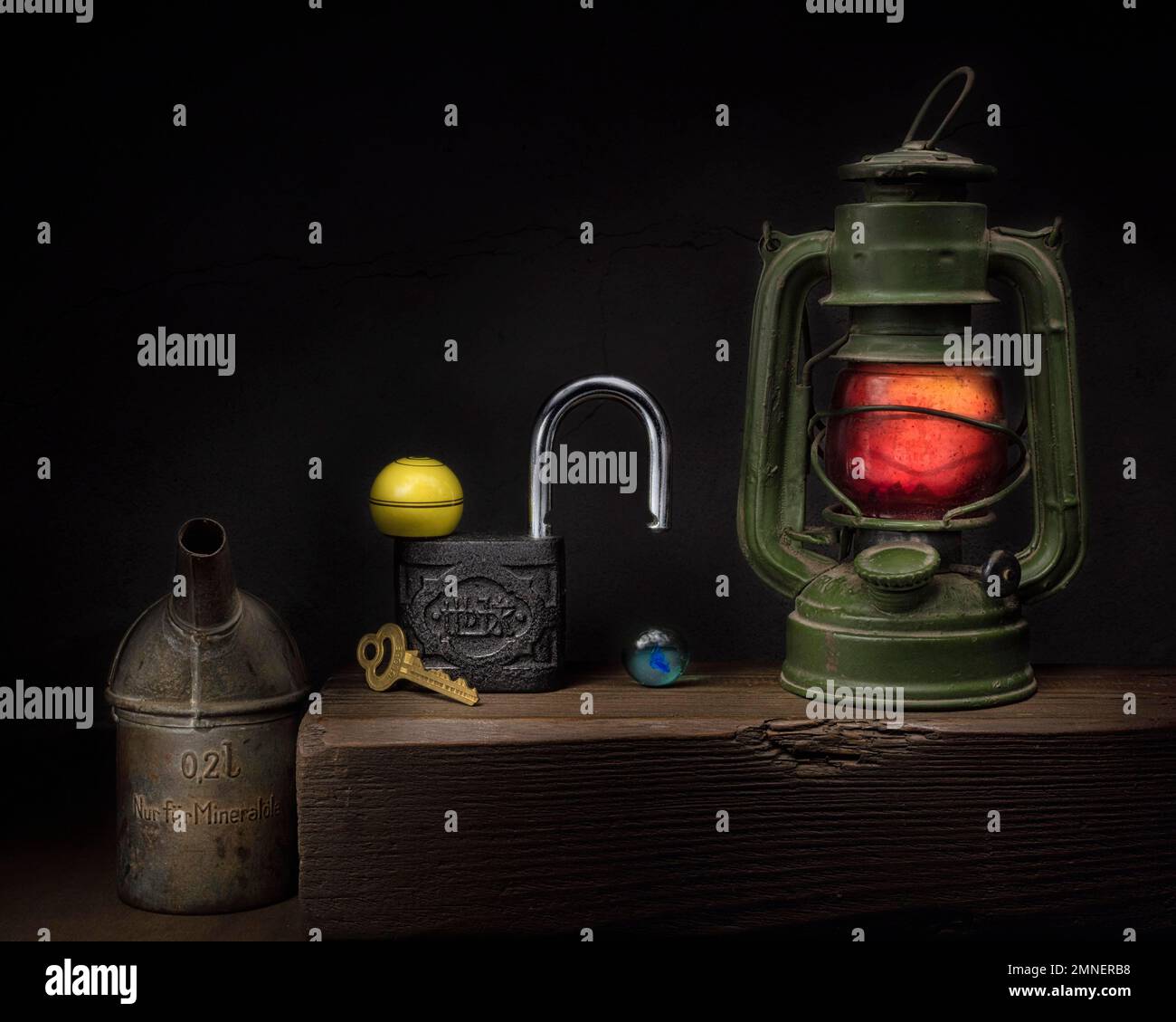 Still life with old oil can, old padlock, paraffin lamp, key and glass ...