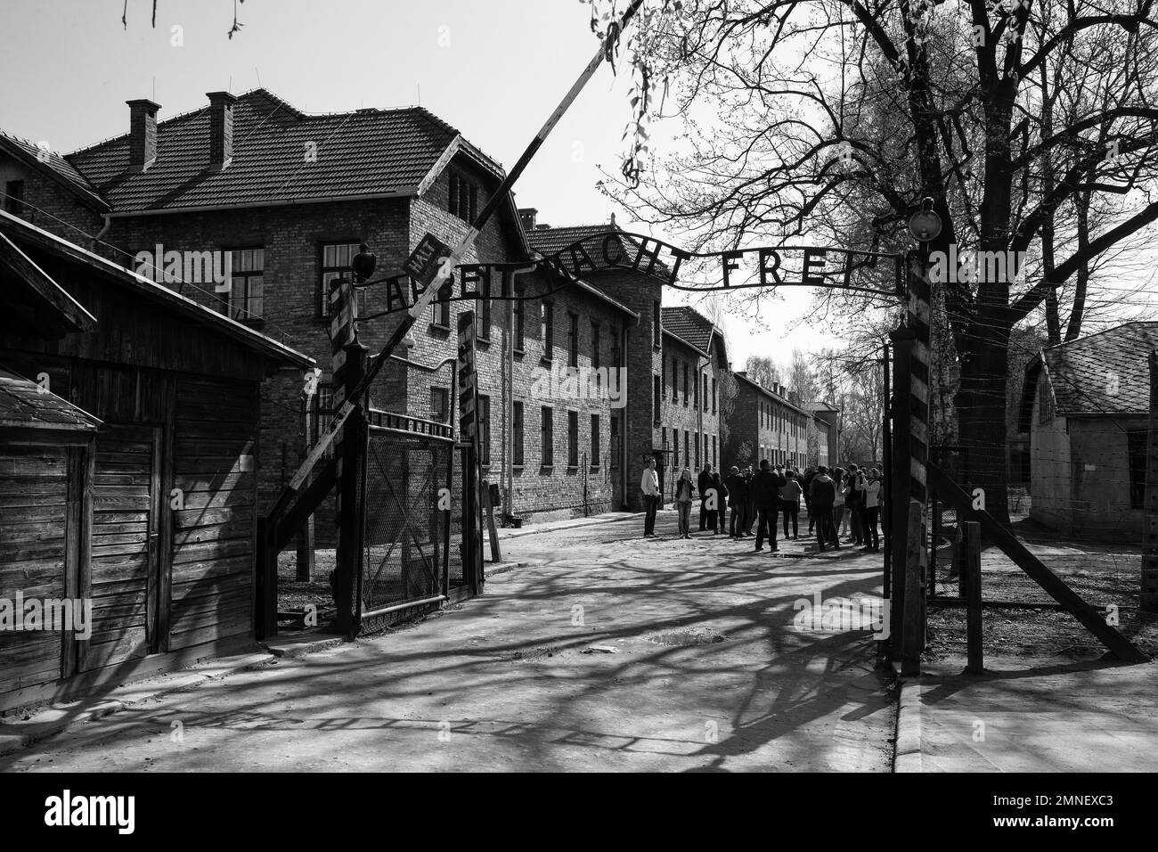The main entrance to Auschwitz concentration camp with the ironic 'Arbeit Macht Frei' slogan (Work sets you free) above the gate in Poland Stock Photo