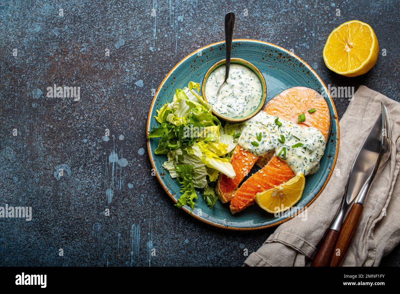 Healthy food meal cooked grilled salmon steaks with white dill sauce ...