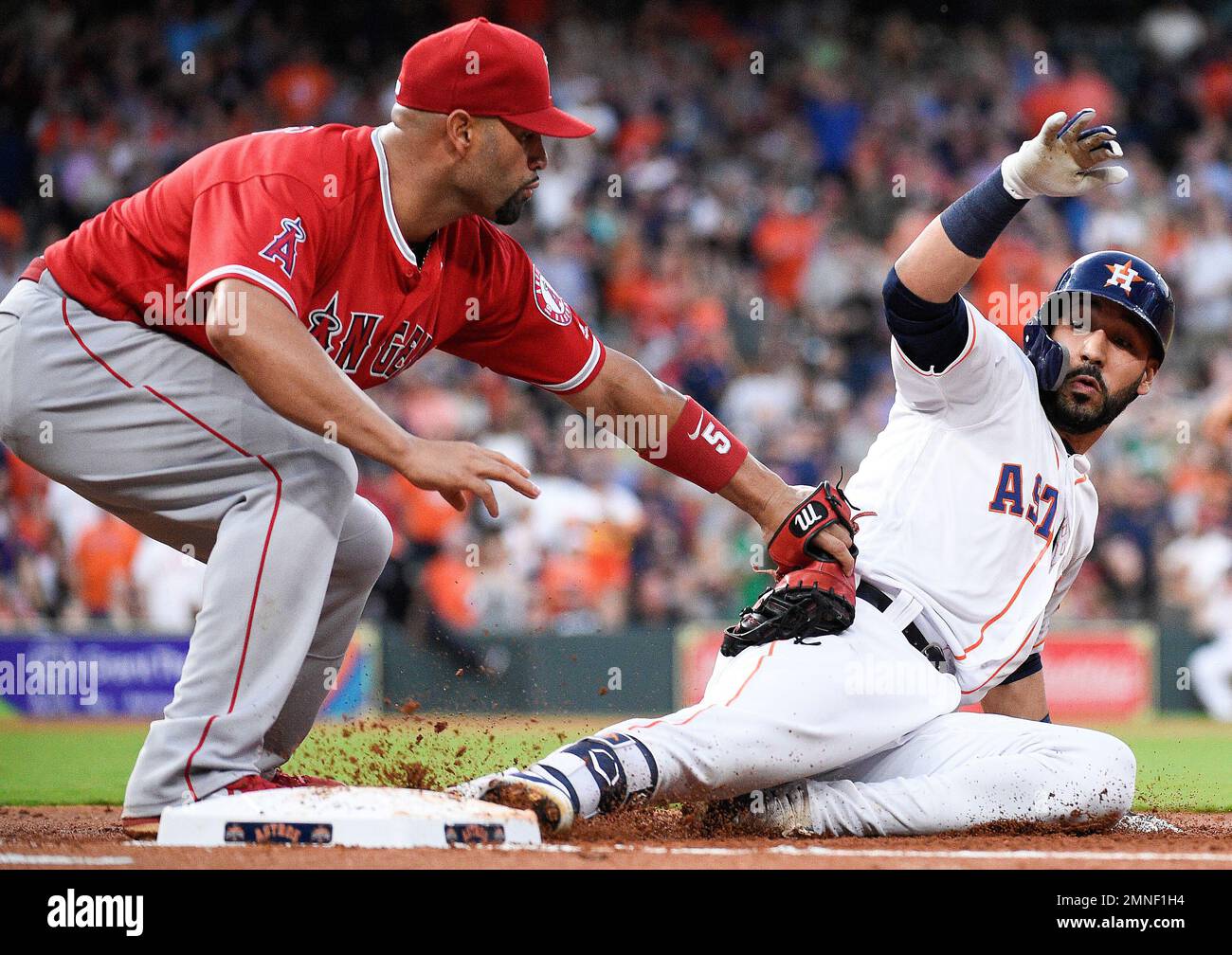 Houston Astros' Marwin Gonzalez, right, is tagged out by Los Angeles Angels  first baseman Albert Pujols on a pickoff during the second inning of a  baseball game Tuesday, April 24, 2018, in