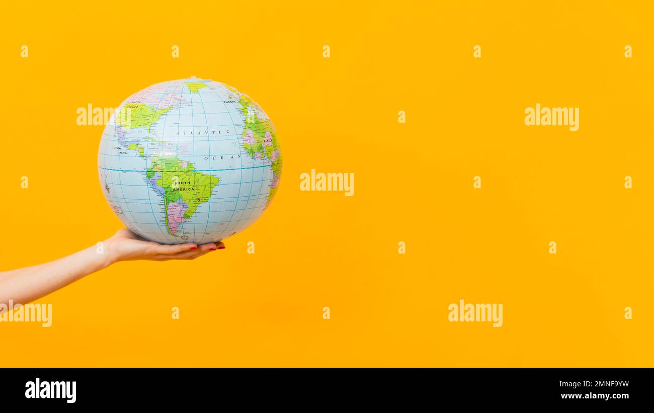 Female arm holding earth globe hi-res stock photography and images - Alamy
