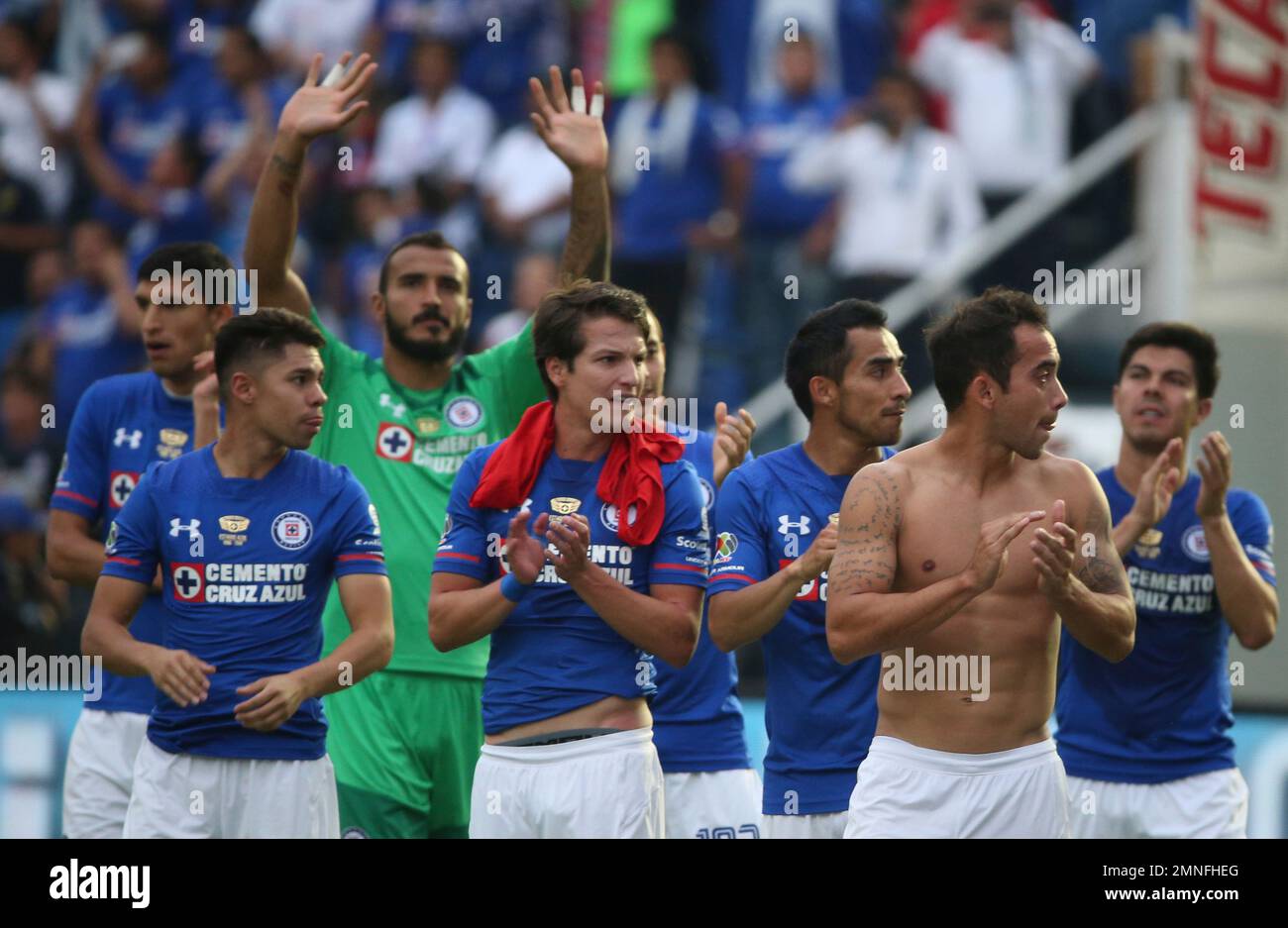 Team members of Cruz Azul make final walk around the field after a ...