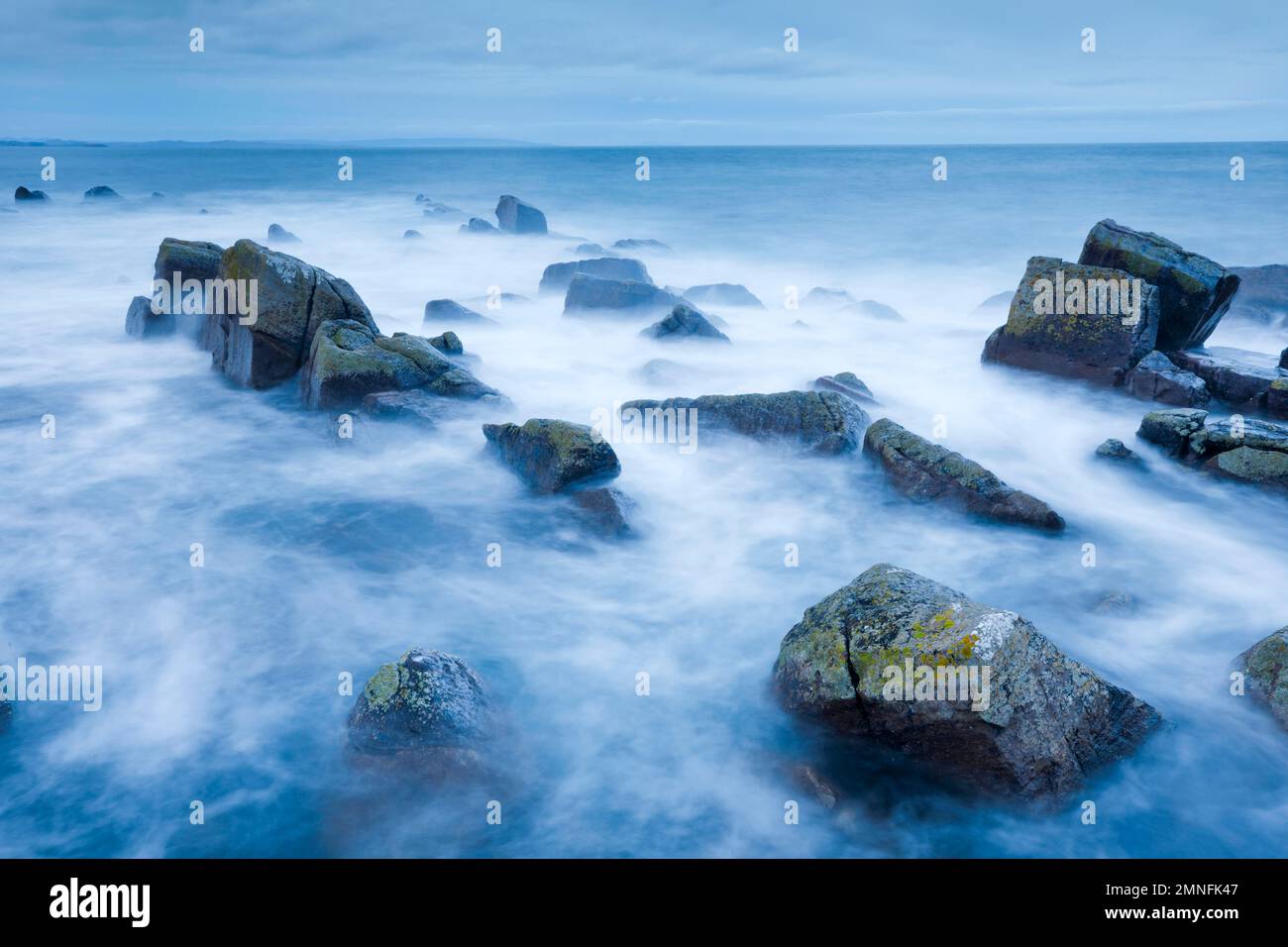 Stormy sea at dawn during the blue hour, at Reiff on the west coast of Scotland Stock Photo