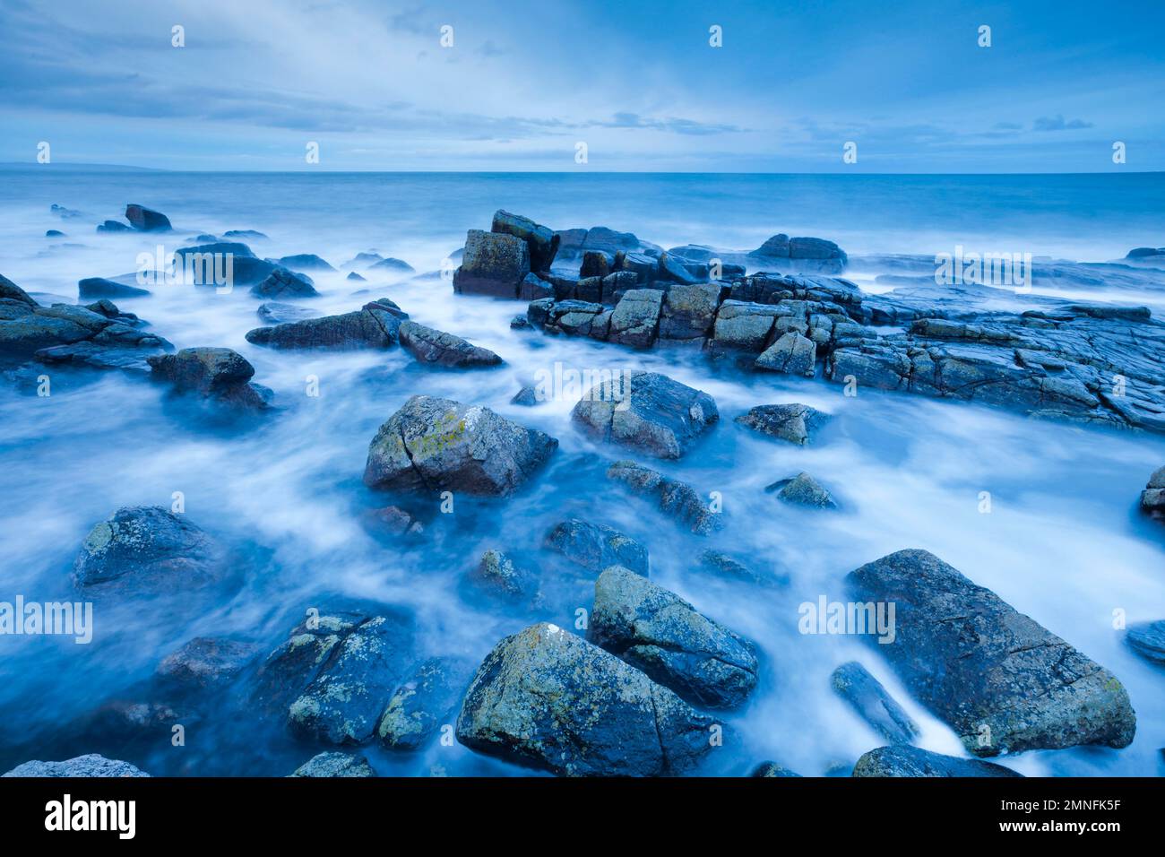 Stormy sea at dawn during the blue hour, at Reiff on the west coast of Scotland Stock Photo