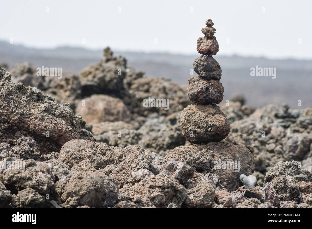 Volcanic stones stacked next to coastal footpath in Lanzarote Stock Photo