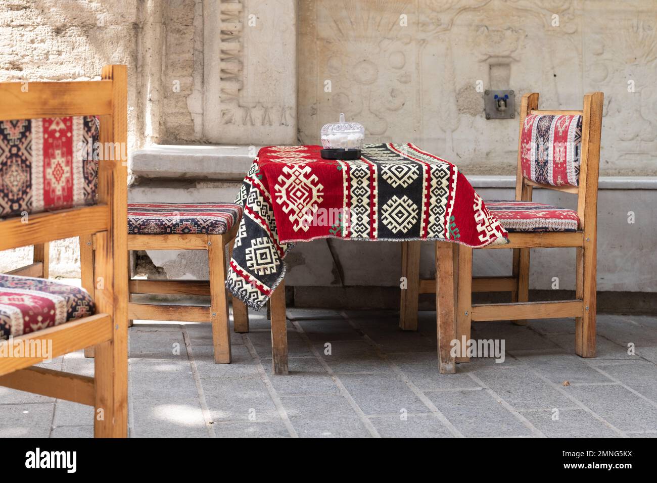 Kilim fabric textile tablecloth and chairs outside cafe, Istanbul, Turkey Stock Photo