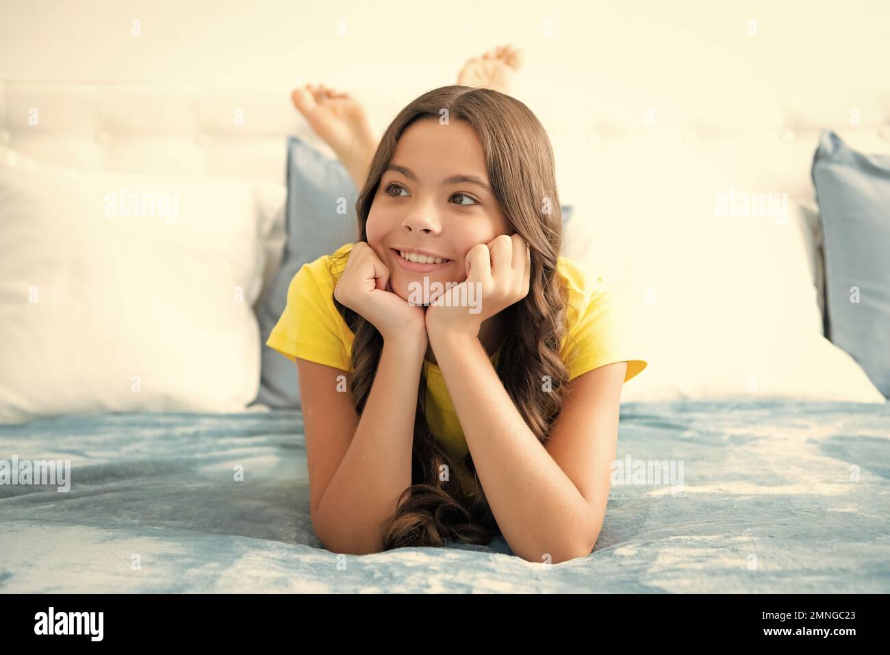 Kid daydreaming, dreaming. Teenager child girl resting in bed at home
