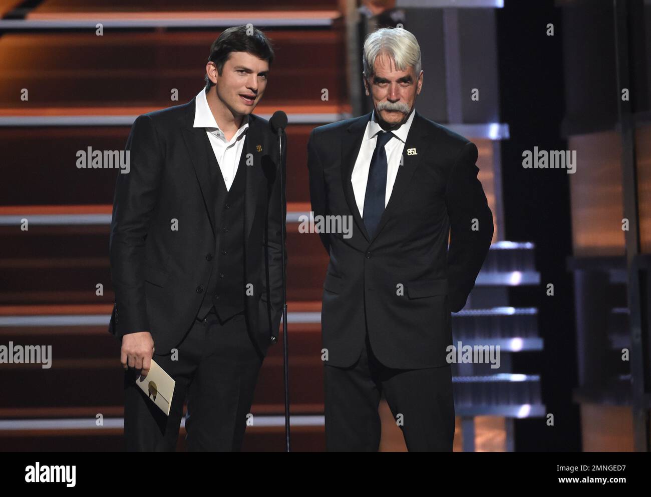 Ashton Kutcher, left, and Sam Elliott present the award for vocal event