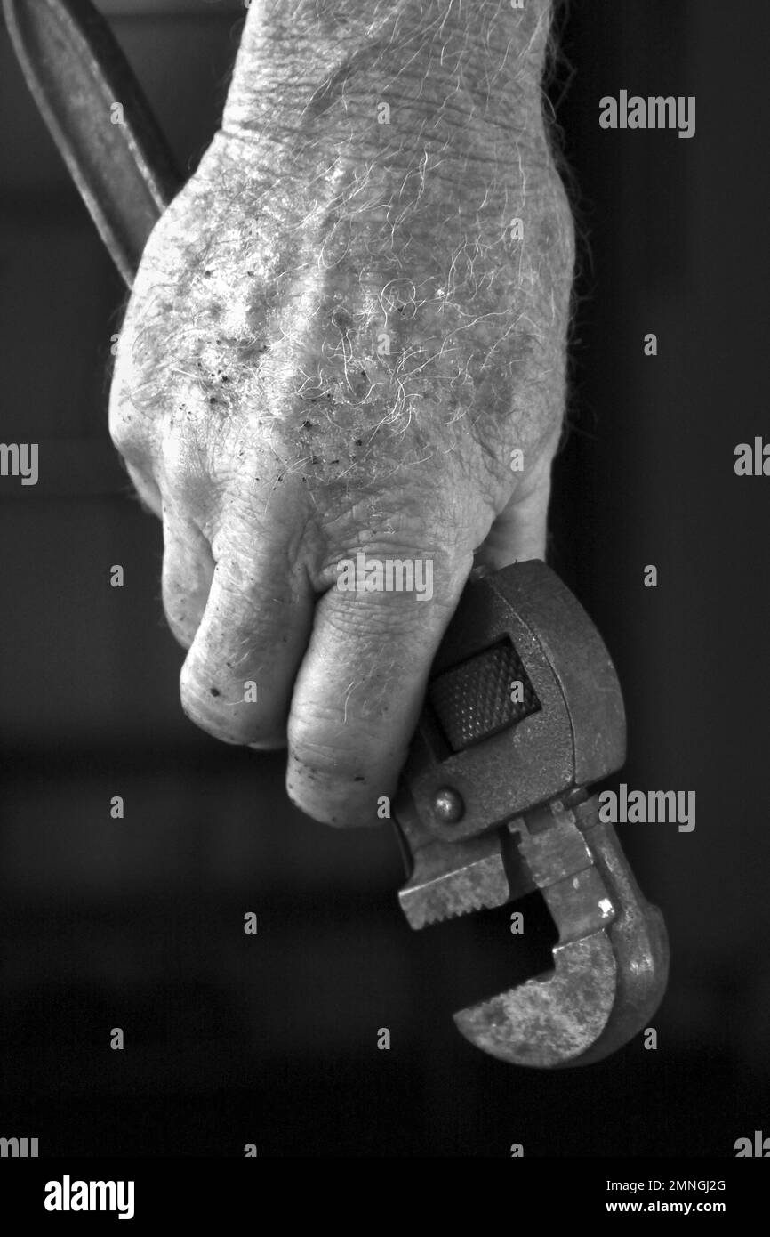 Hand holding Adjustable Wrench Stock Photo