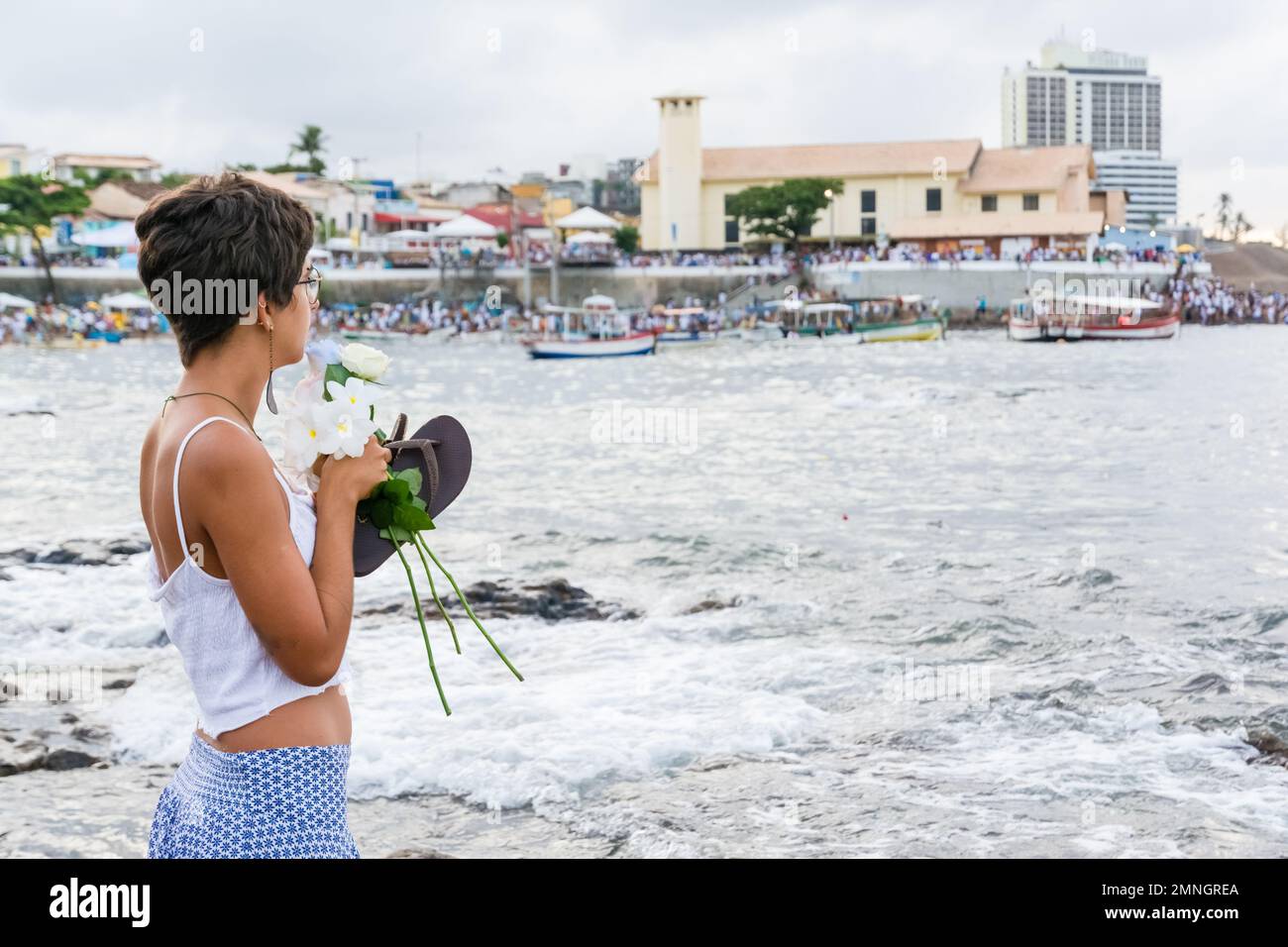 Salvador, Bahia, Brazil February 02, 2017 A woman who admires Candomble throws flowers into