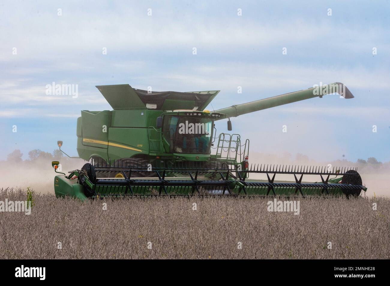 A farmer using a John Deere S770 Combine to harvest soybeans on his 135