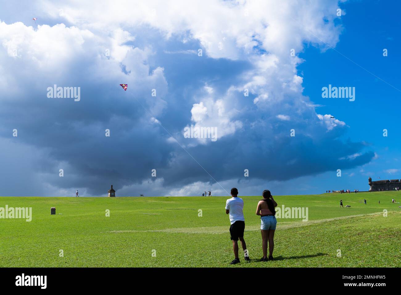 Visitors at the San Juan National Historic Site fly a kite in the lush