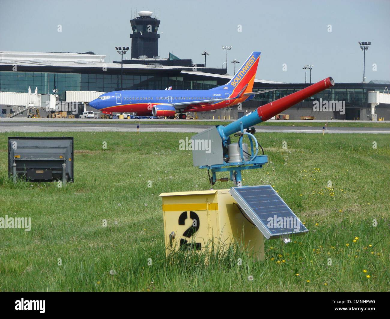 Propane cannons, like the one used in this airport, are also used at agricultural fields, and other areas to disperse wildlife (primarily birds) away from damage situations. Some have timers that automatically turn them on and off each day or have remote-controlled activators. Stock Photo