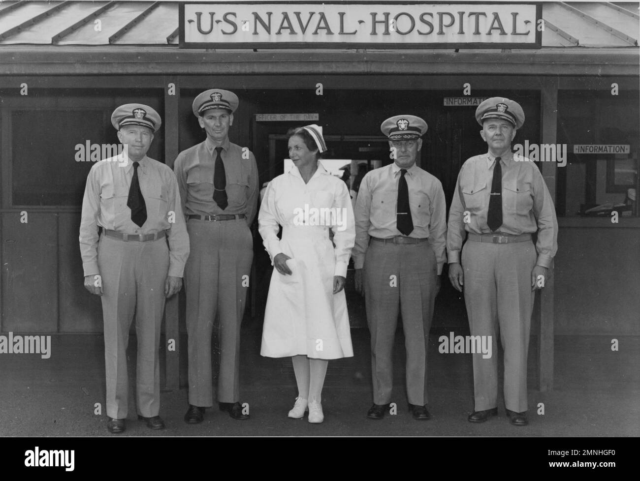 Base 8, U.S. Naval Hospital, Pearl Harbor, Territory of Hawaii. Vice Admiral Ross T. McIntire, Captain L.O. Stone, Lieutenant Commander Susan J. English, Captain W.A. Wylie, Rear Admiral C.B. Camerer,   Pearl Harbor, Hawaii / Territory of Hawaii ca. 1940s or 1950s Stock Photo