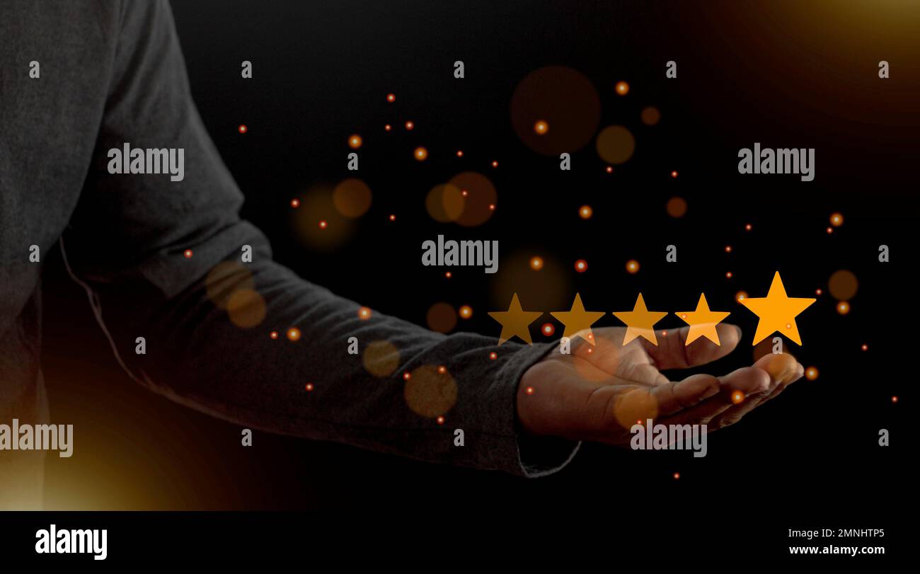 Satisfaction close up on customer man hand pressing on screen with five star rating feedback icon and press level excellent rank for giving best score Stock Photo
