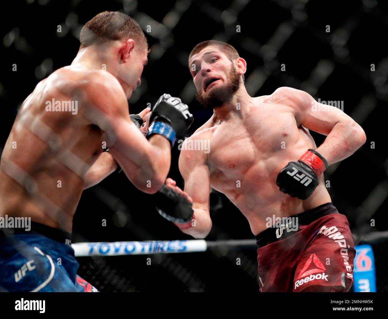 Al Iaquinta, left, deflects a punch from Russia's Khabib Nurmagomedov ...