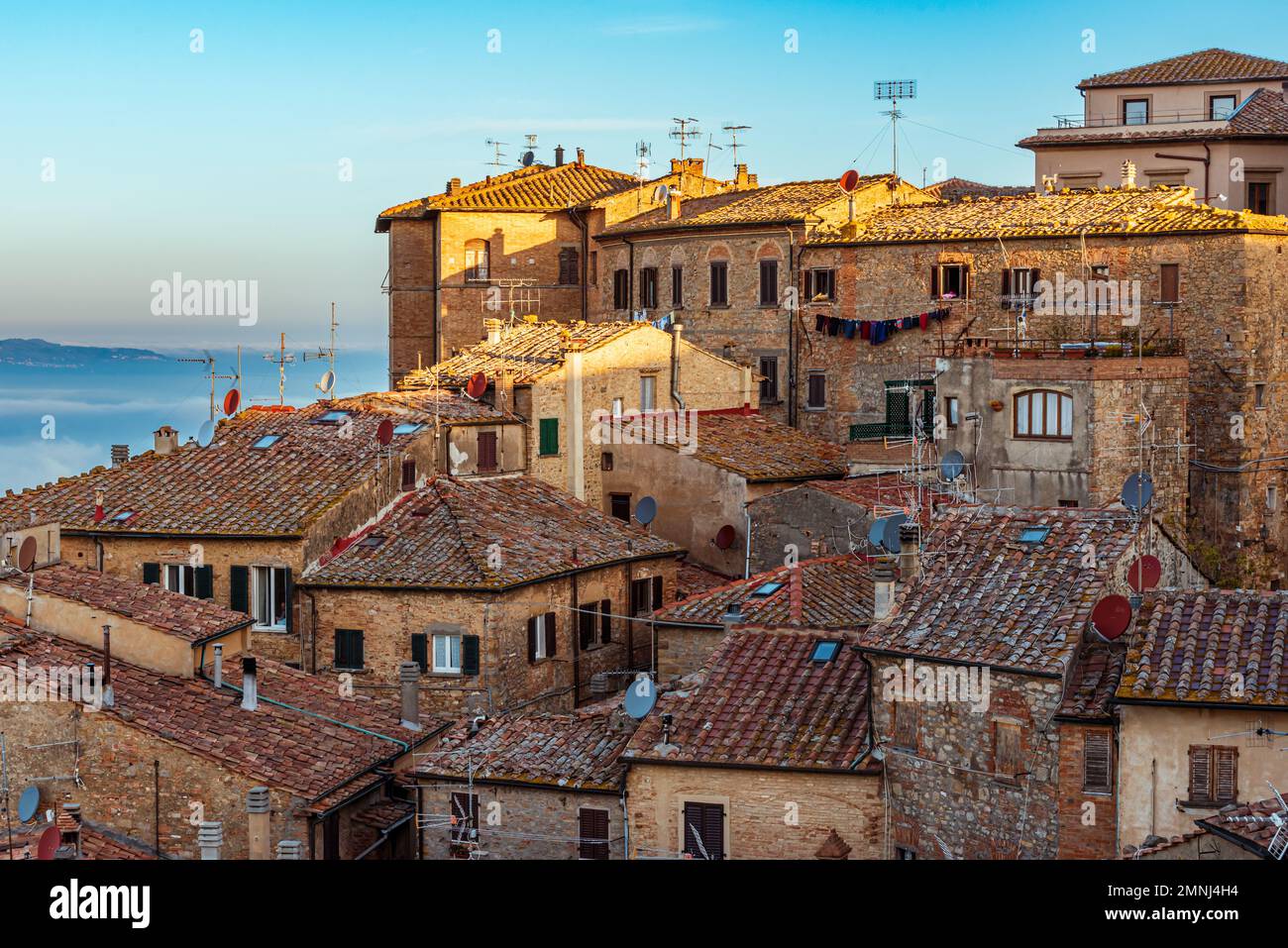 View over the tile rooftops and stone houses of the Hill Town of Volterra, Tuscany, Italy Stock Photo