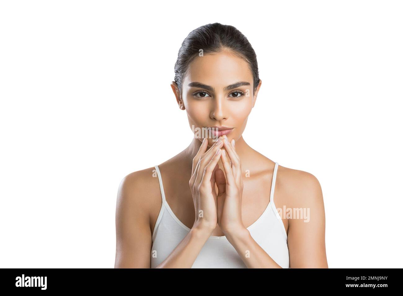Portrait of serious young woman with hands clasped Stock Photo