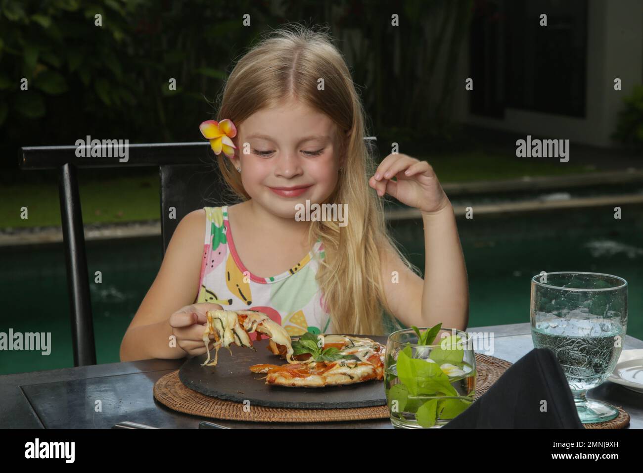 Little girl eating pizza Margherita at the restaurant Stock Photo