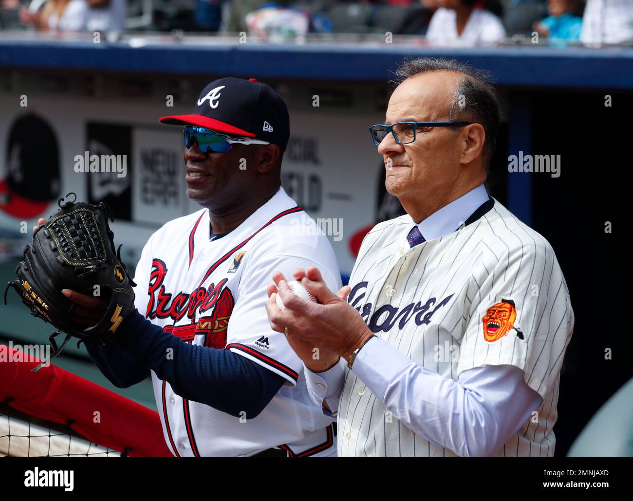 Former Atlanta Braves player and former New York Yankees manager Joe Torre  and Atlanta Braves first base coach Eric Young (2) watch a pregame ceremony  to mark the 50th anniversarsy of the