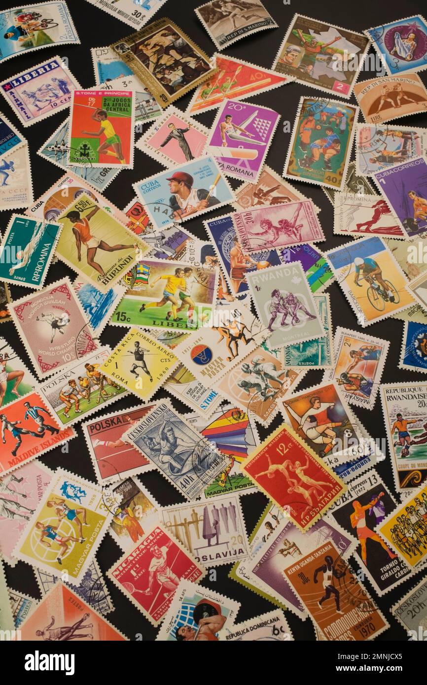 Old assorted postage stamps from various Countries commemorating various olympic sports. Stock Photo