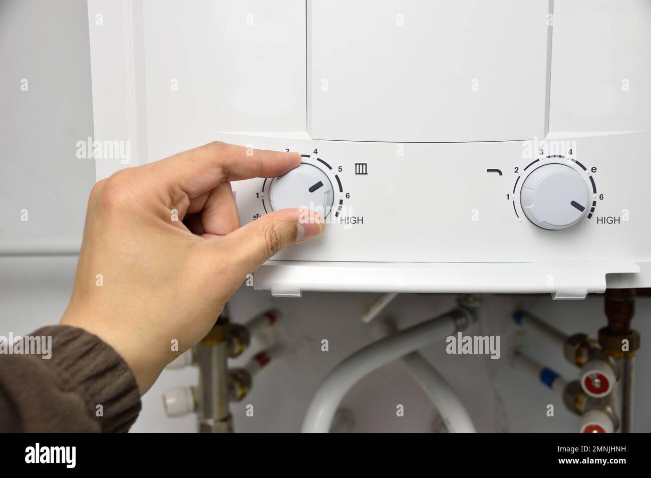 hand rotate temperature adjuster of water heater.High temp Stock Photo