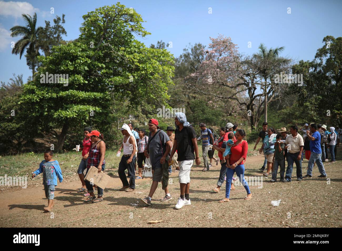 Central American migrants arrive to a sports center during the