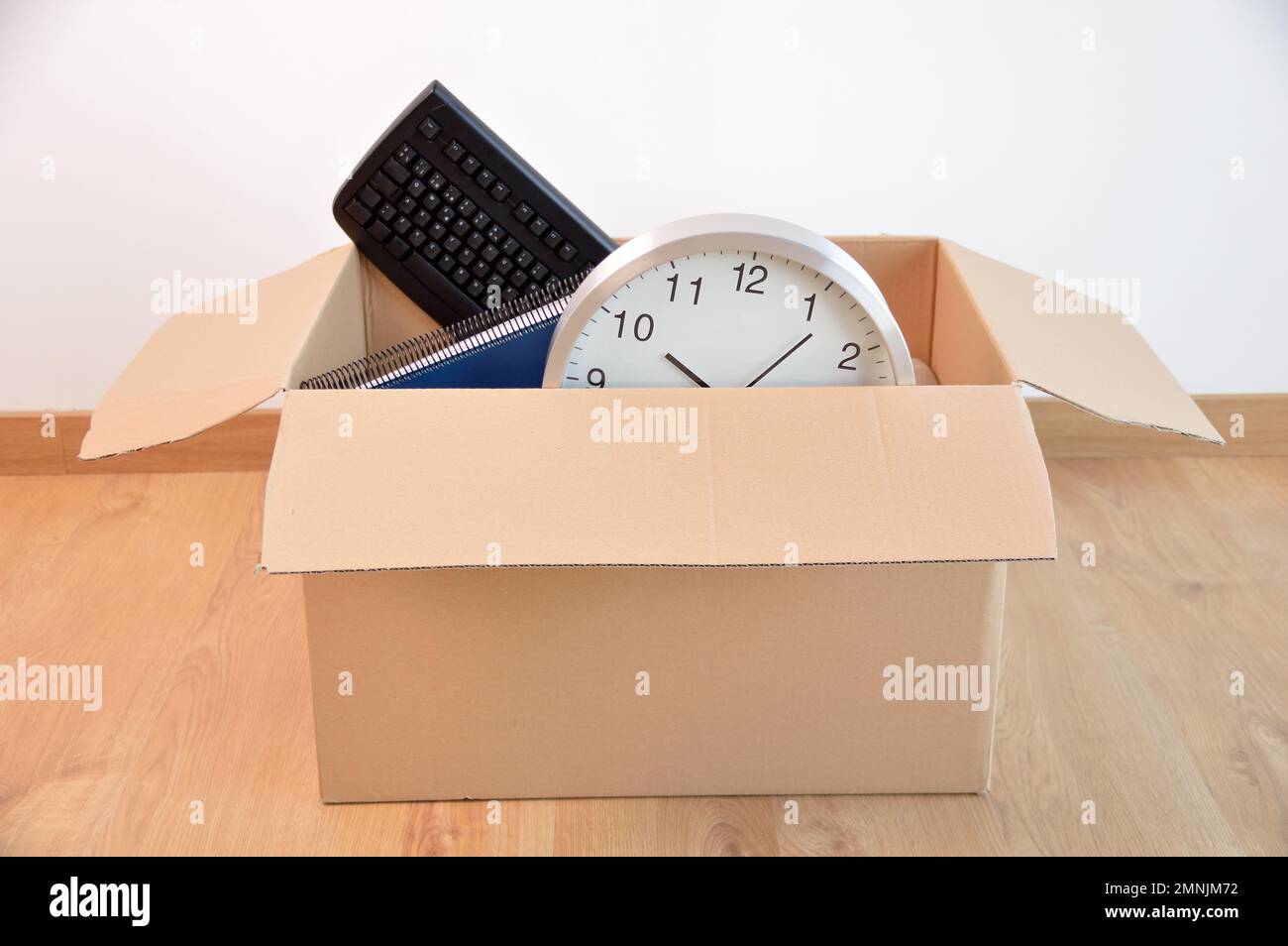 Office accessories in a cardboard box at office. Stock Photo