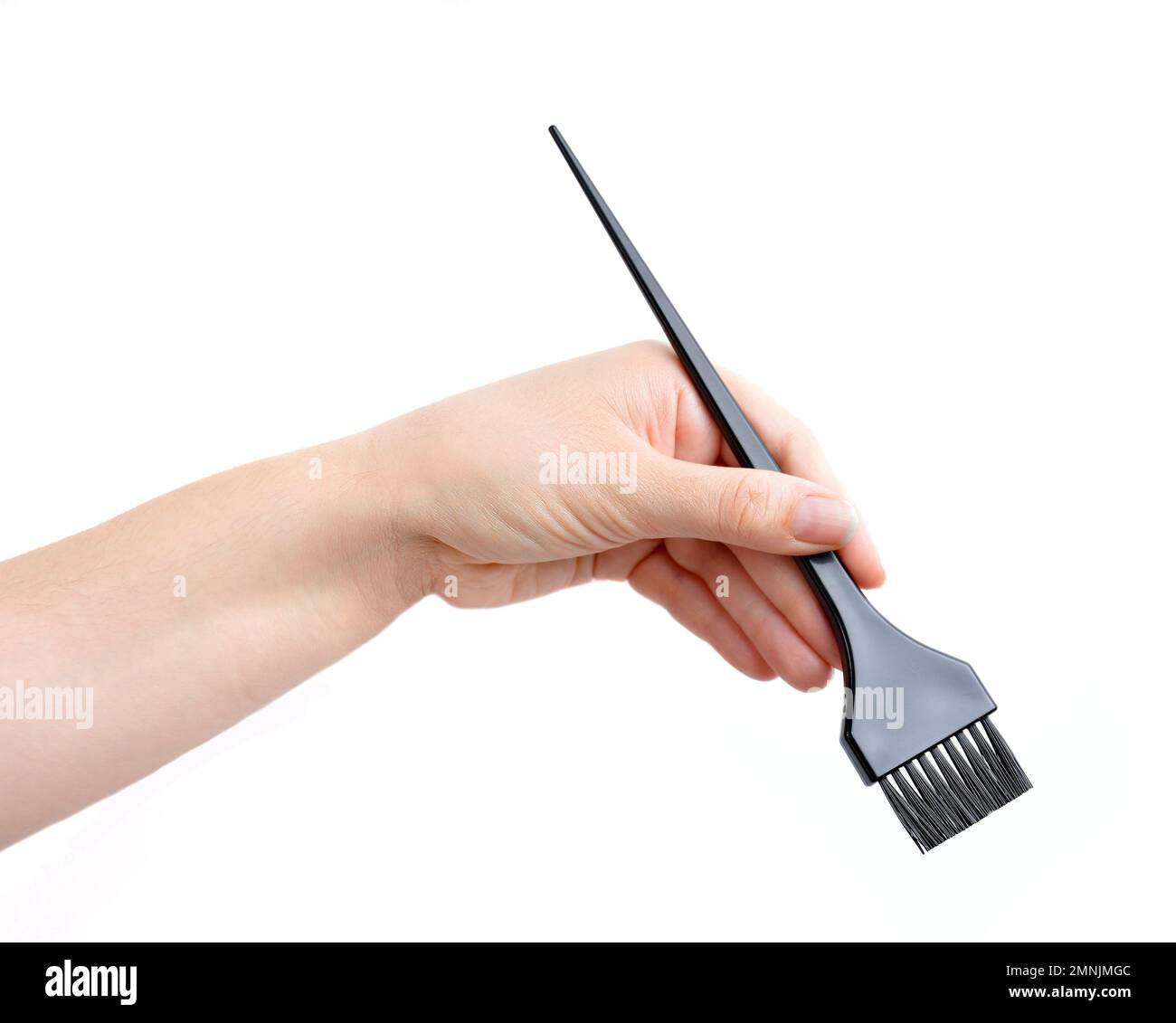 hand picking up a brush to dye the hair Stock Photo Alamy