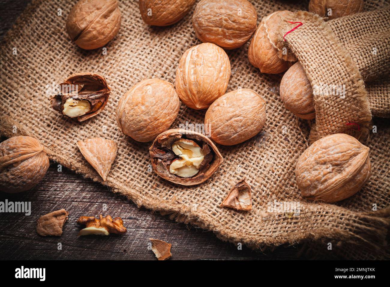 handful of nuts on a sheet of jute with broken shell Stock Photo Alamy
