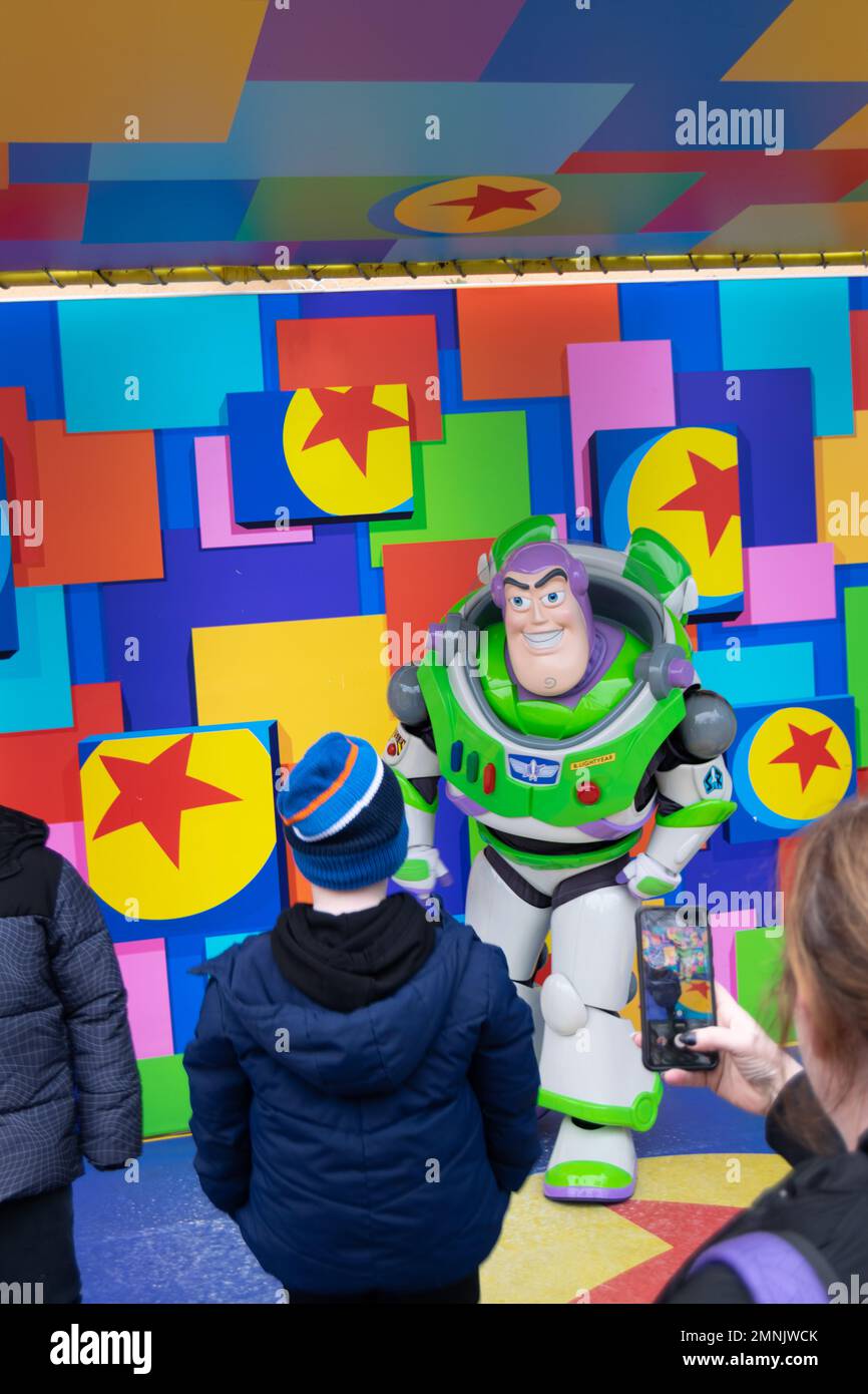 Taking pictures wit buzz lightyear at Disneyland Paris park. Kids taking pictures with their heroes. Disney attractions. Stock Photo