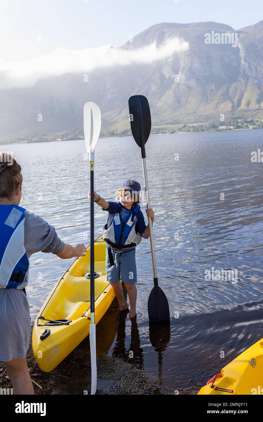 South Africa, Stanford, Boy and teenage girl (10-11, 16-17) preparing for kayaking Stock Photo