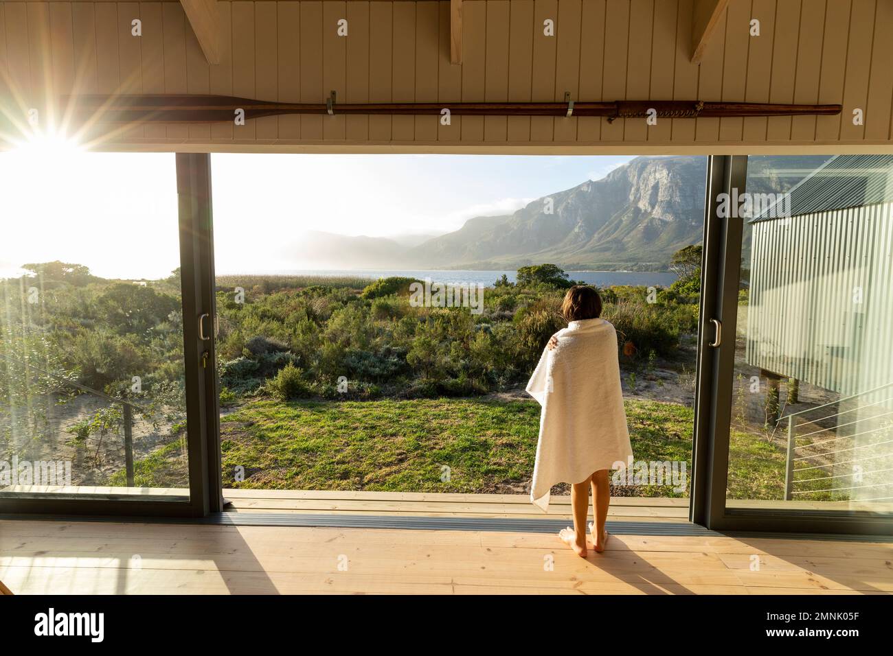 South Africa, Stanford, Boy (10-11) looking at lagoon and Klein mountains Stock Photo