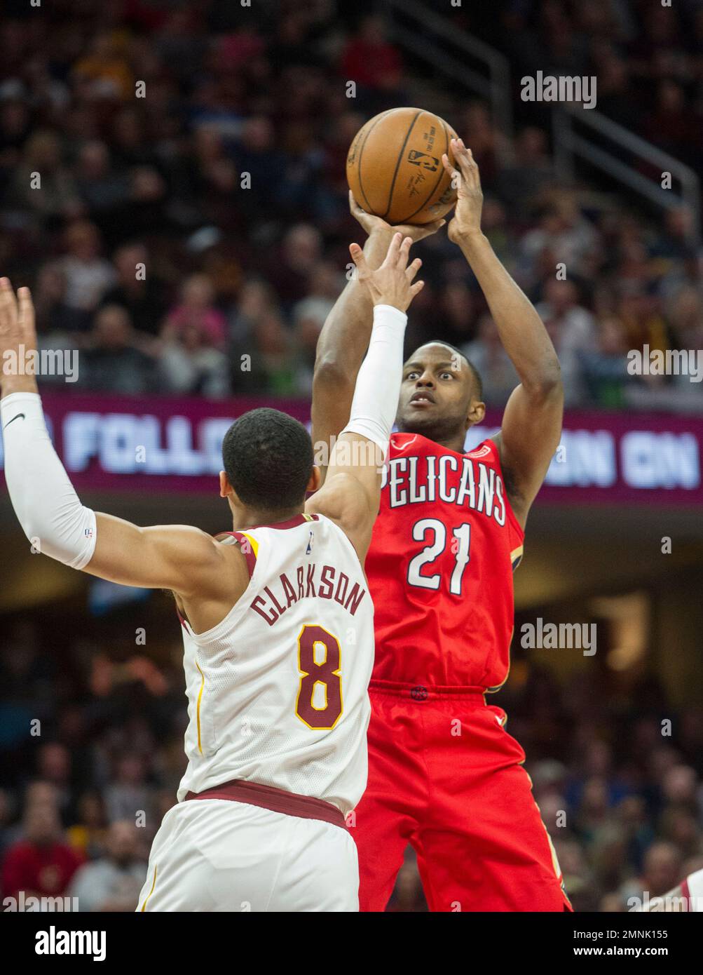 New Orleans Pelicans' Darius Miller (21) shoots over Cleveland Cavaliers' Jordan Clarkson (8